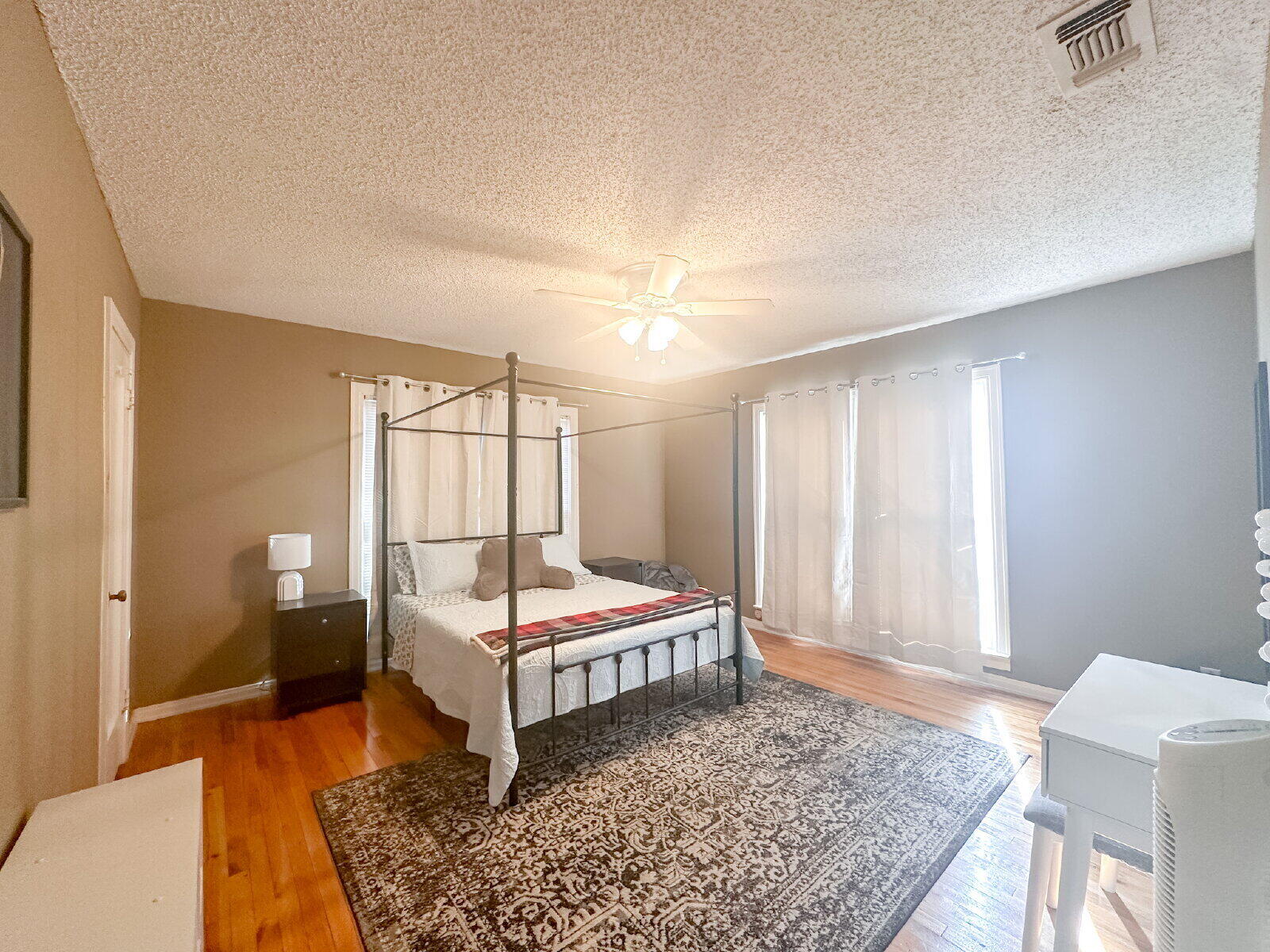 2611 29th Street Lubbock, TX 79410 - Photo 4 of 9 a bedroom with a bed and wooden floor