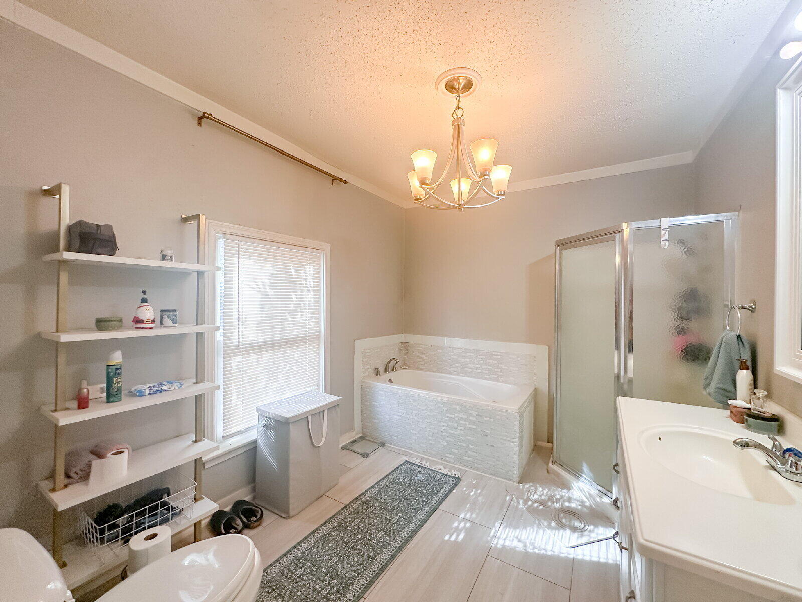 2611 29th Street Lubbock, TX 79410 - Photo 5 of 9 a spacious bathroom with a double vanity sink a mirror and a bathtub