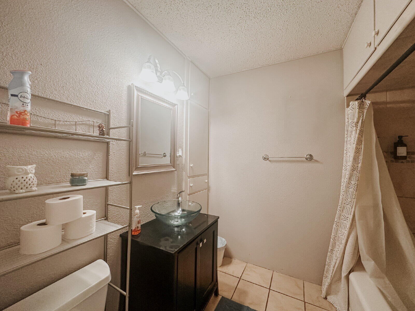 2611 29th Street Lubbock, TX 79410 - Photo 7 of 9 a bathroom with a sink a toilet and vanity