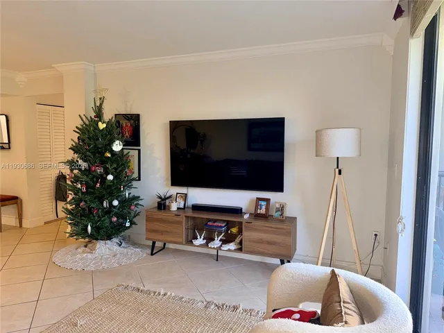 a bedroom with a bed and a flat tv screen on the dresser