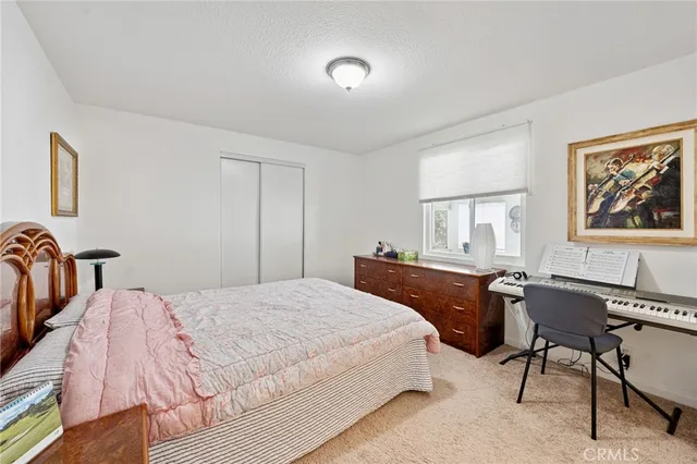 a bedroom with a bed and a desk