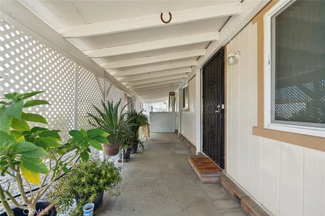 a hallway with potted plants in front of door