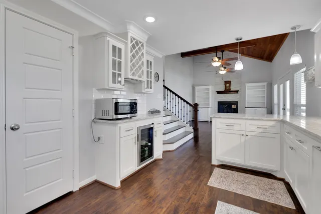 a kitchen with cabinets and wooden floor