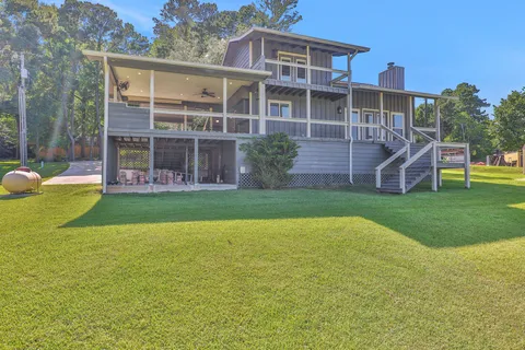 a view of a house with a yard and sitting area