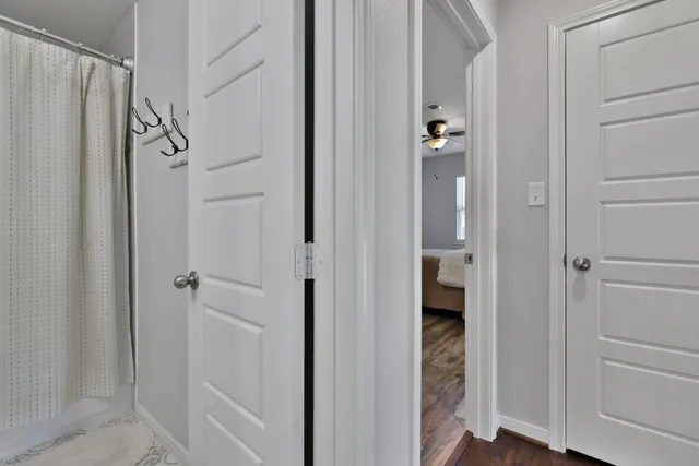 a bathroom with a shower and a glass door