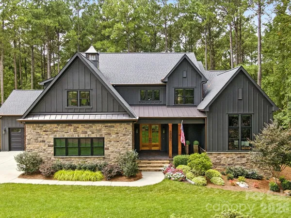a front view of house with yard and green space
