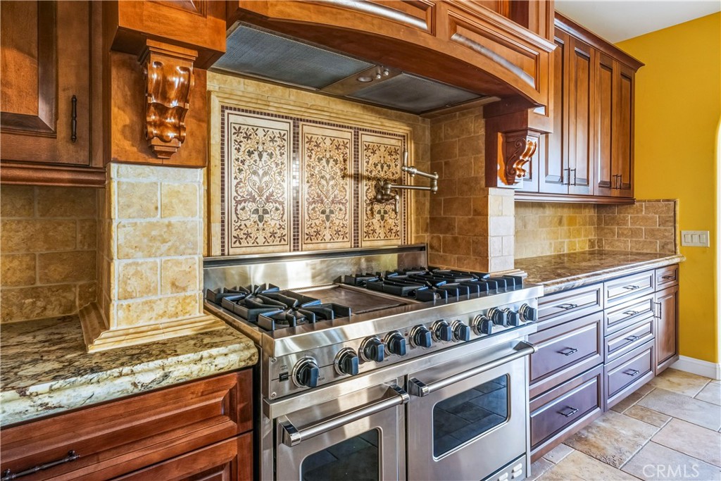 13 Cassis Circle Rancho Mirage, CA 92270 - Photo 14 of 51 a kitchen with granite countertop a stove and a sink