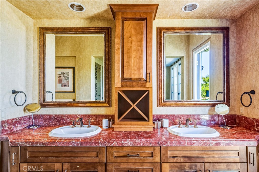 13 Cassis Circle Rancho Mirage, CA 92270 - Photo 32 of 70 a bathroom with a granite countertop sink and a mirror