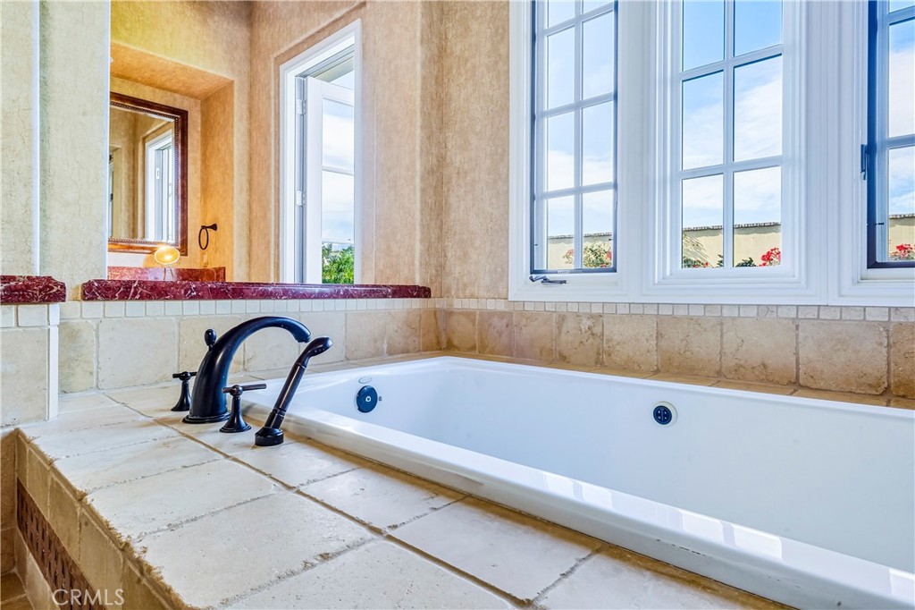 13 Cassis Circle Rancho Mirage, CA 92270 - Photo 35 of 70 a bath tub sitting in a bathroom next to a window