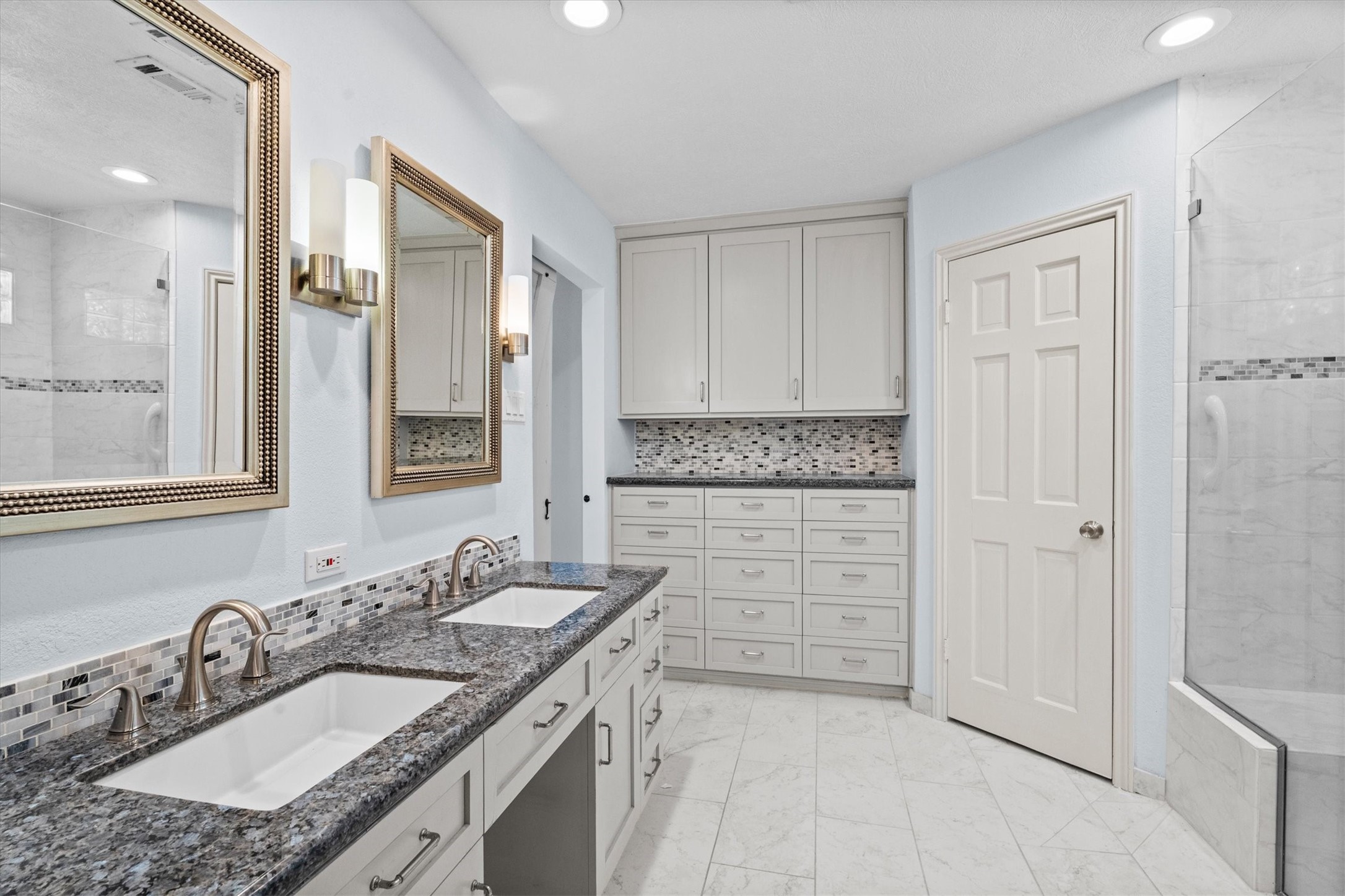 25319 Old Carriage Lane Spring, TX 77373 - Photo 24 of 35 a spacious bathroom with a granite countertop sink and a mirror