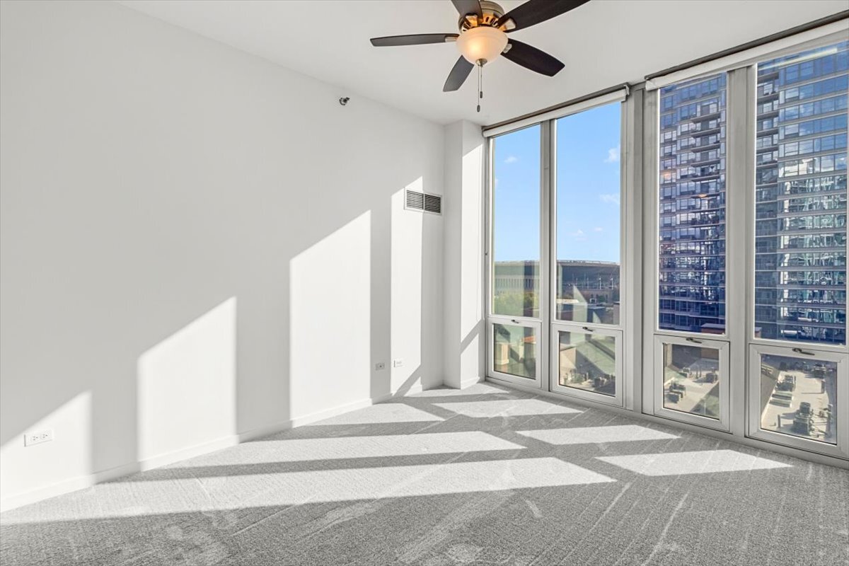 1600 South Indiana Avenue, Unit 908 Chicago, IL 60616 - Photo 18 of 26 a view of a livingroom with a ceiling fan and window