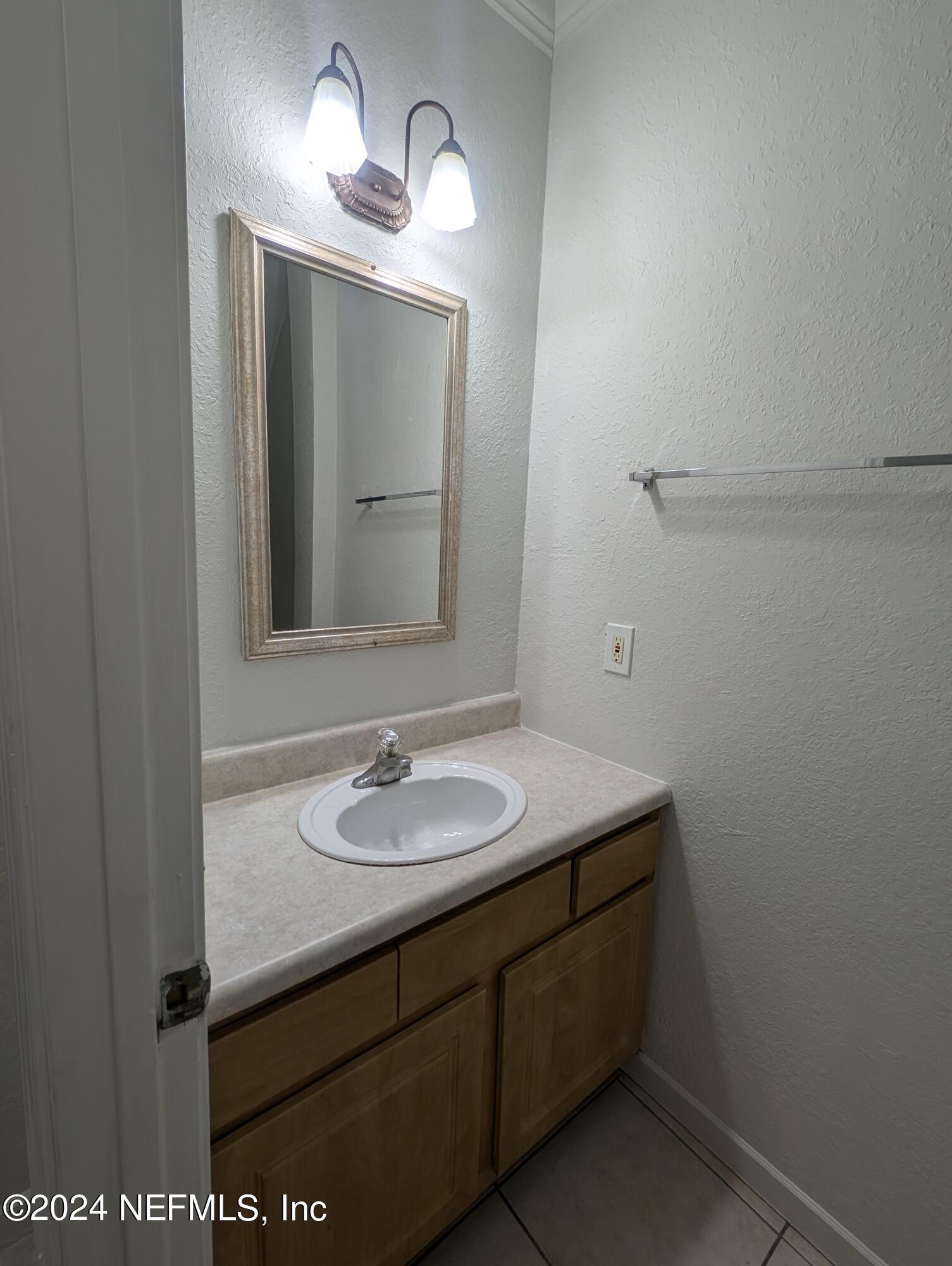 114 Cedar Street, Unit 8 St. Augustine, FL 32084 - Photo 12 of 39 a bathroom with a sink and a mirror