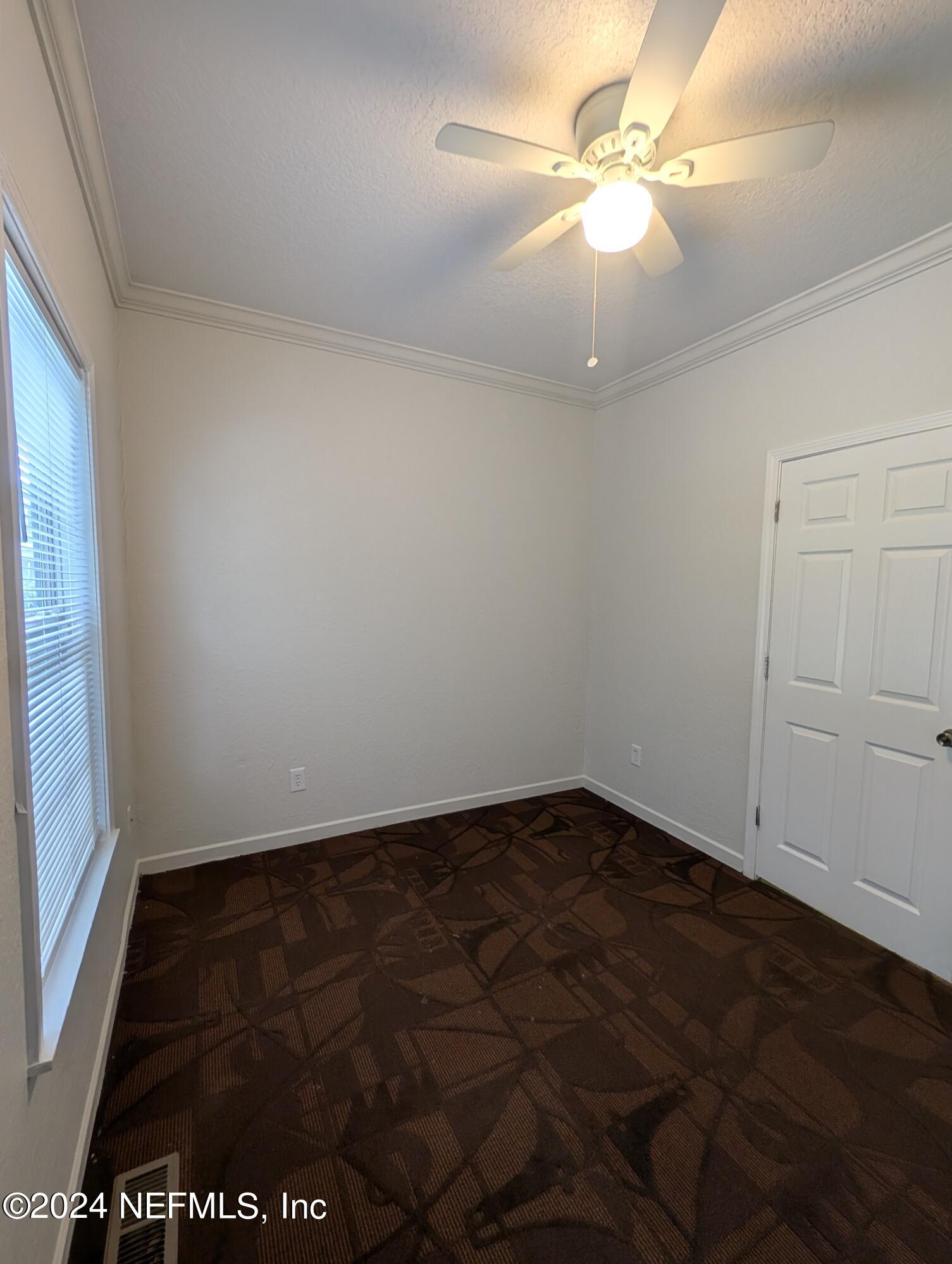 114 Cedar Street, Unit 8 St. Augustine, FL 32084 - Photo 15 of 39 an empty room with a fan & a ceiling fan