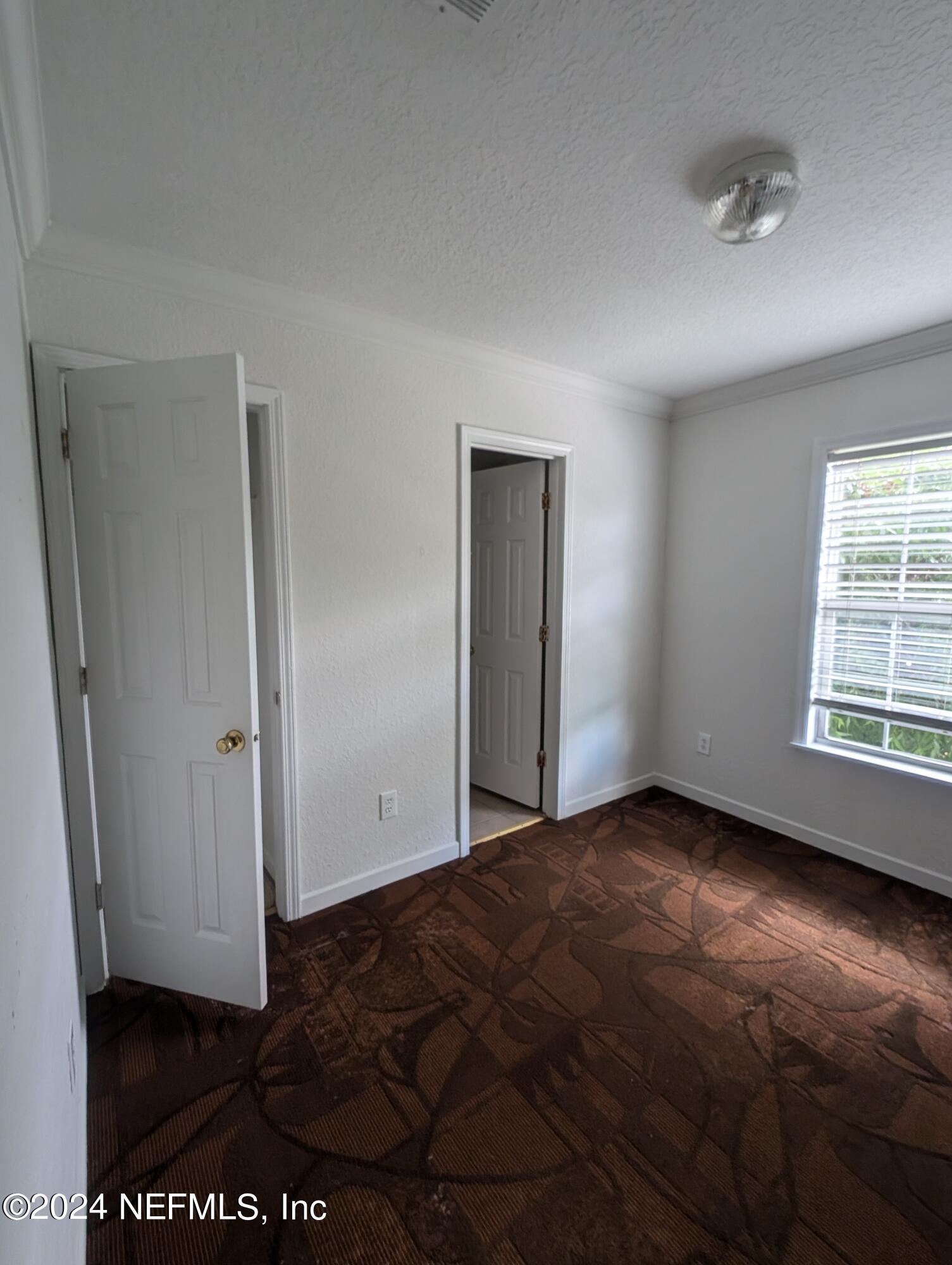 114 Cedar Street, Unit 8 St. Augustine, FL 32084 - Photo 21 of 39 an empty room with windows