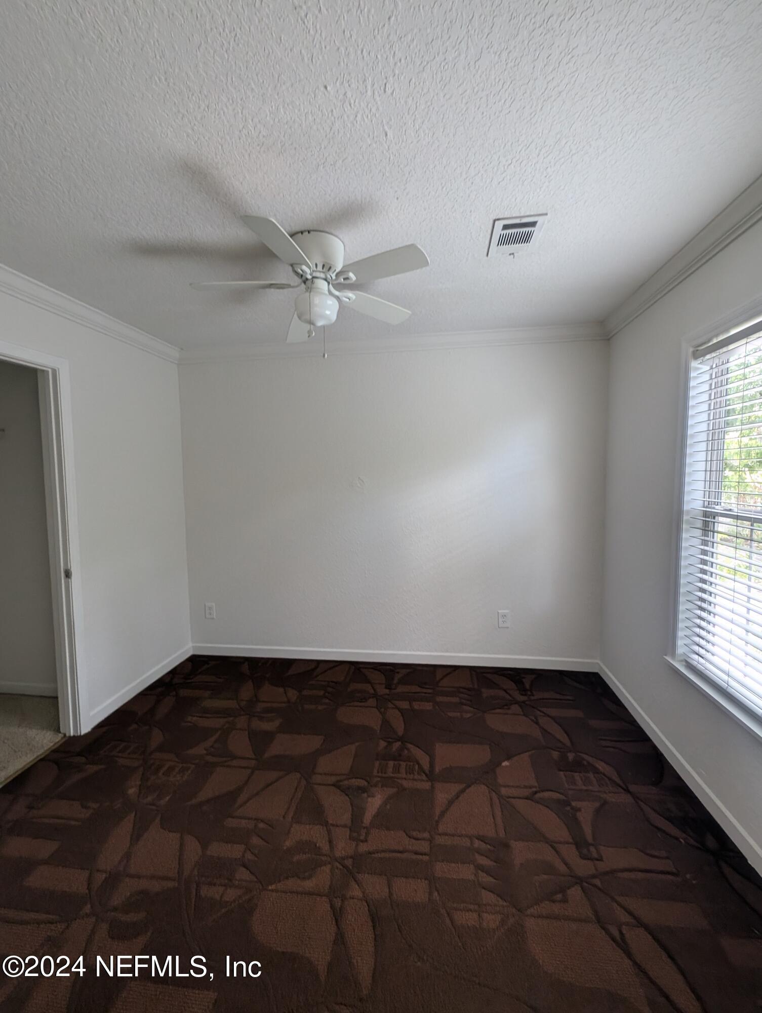 114 Cedar Street, Unit 8 St. Augustine, FL 32084 - Photo 26 of 39 an empty room with windows and fan
