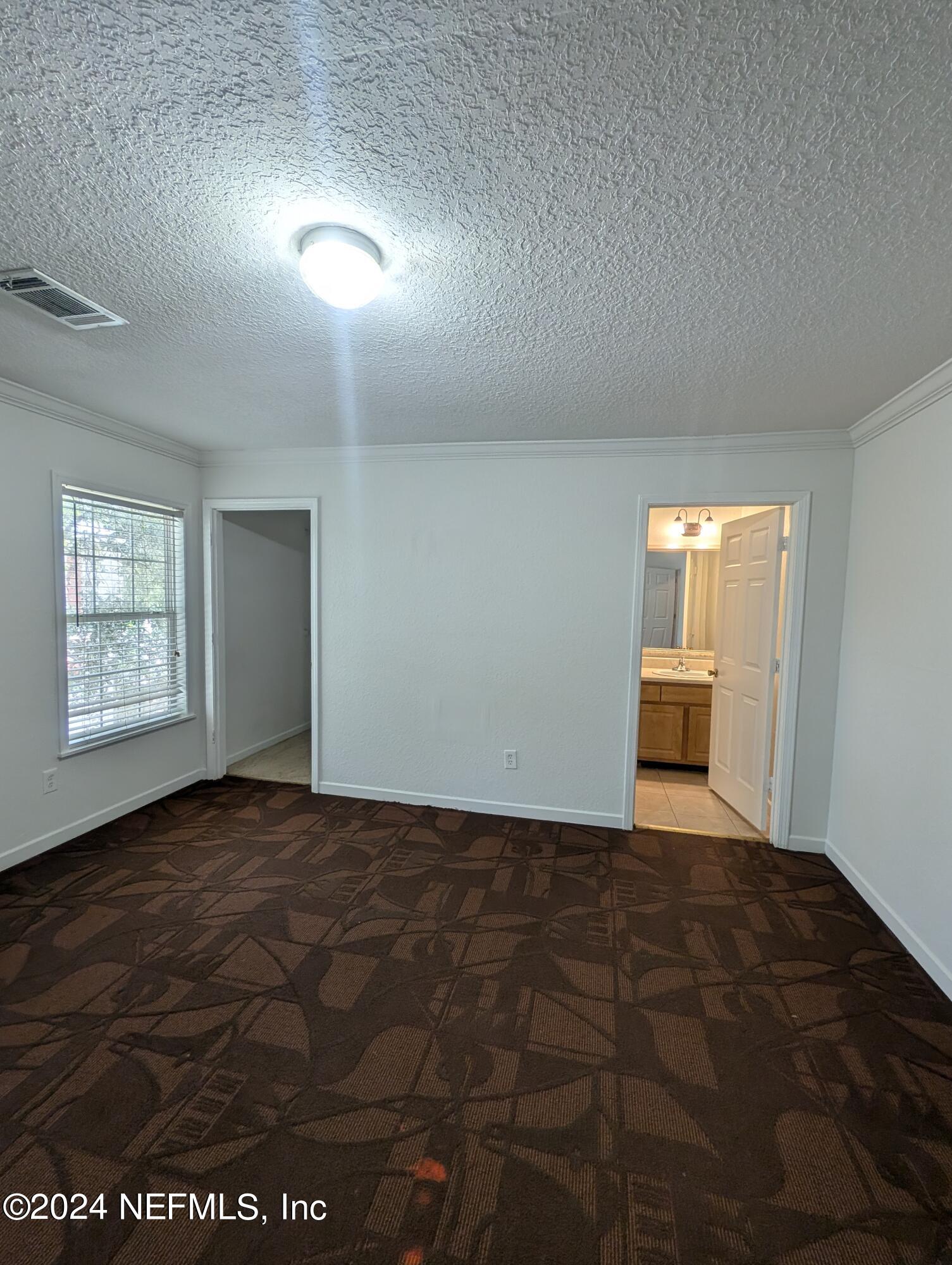 114 Cedar Street, Unit 8 St. Augustine, FL 32084 - Photo 28 of 39 a view of an empty room and window