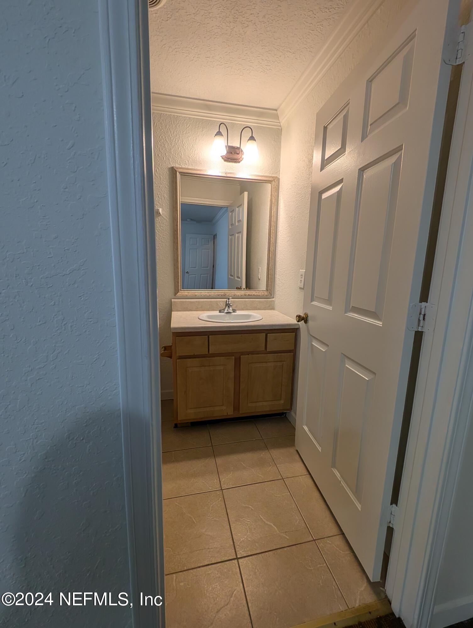 114 Cedar Street, Unit 8 St. Augustine, FL 32084 - Photo 30 of 39 a bathroom with a sink a mirror and a toilet