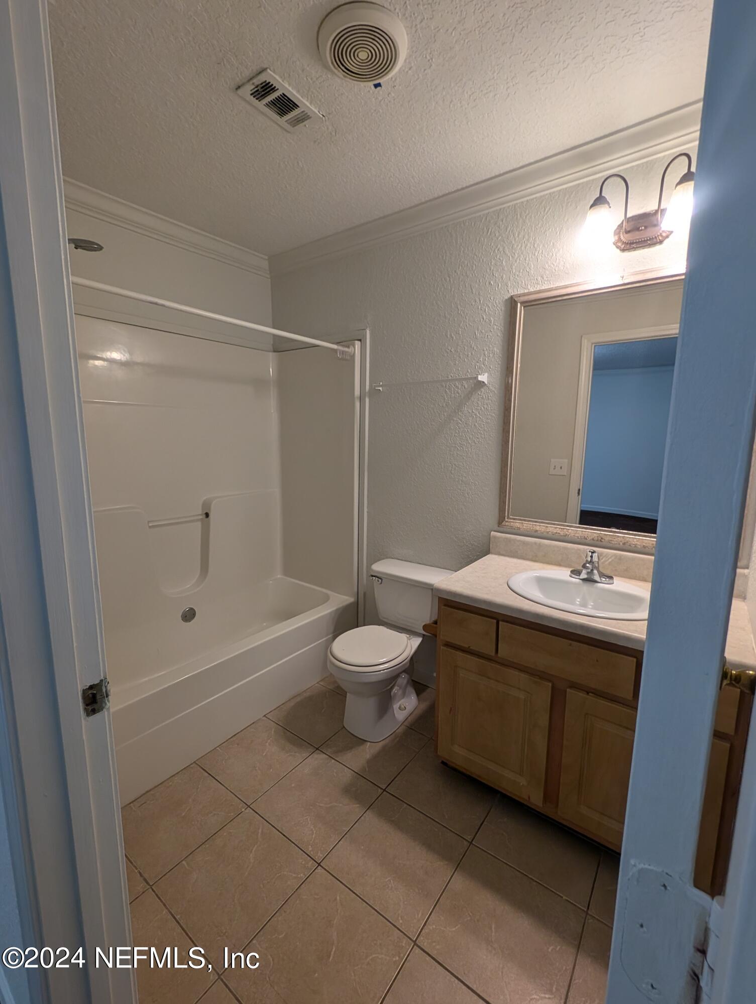 114 Cedar Street, Unit 8 St. Augustine, FL 32084 - Photo 31 of 39 a bathroom with a granite countertop sink toilet and shower