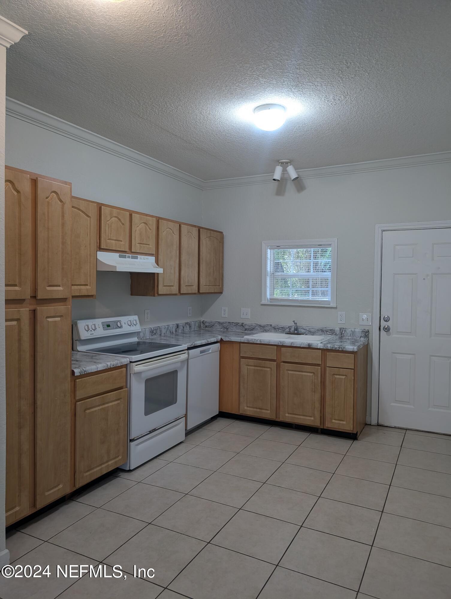 114 Cedar Street, Unit 8 St. Augustine, FL 32084 - Photo 5 of 39 a kitchen with stainless steel appliances granite countertop a stove a sink and a refrigerator