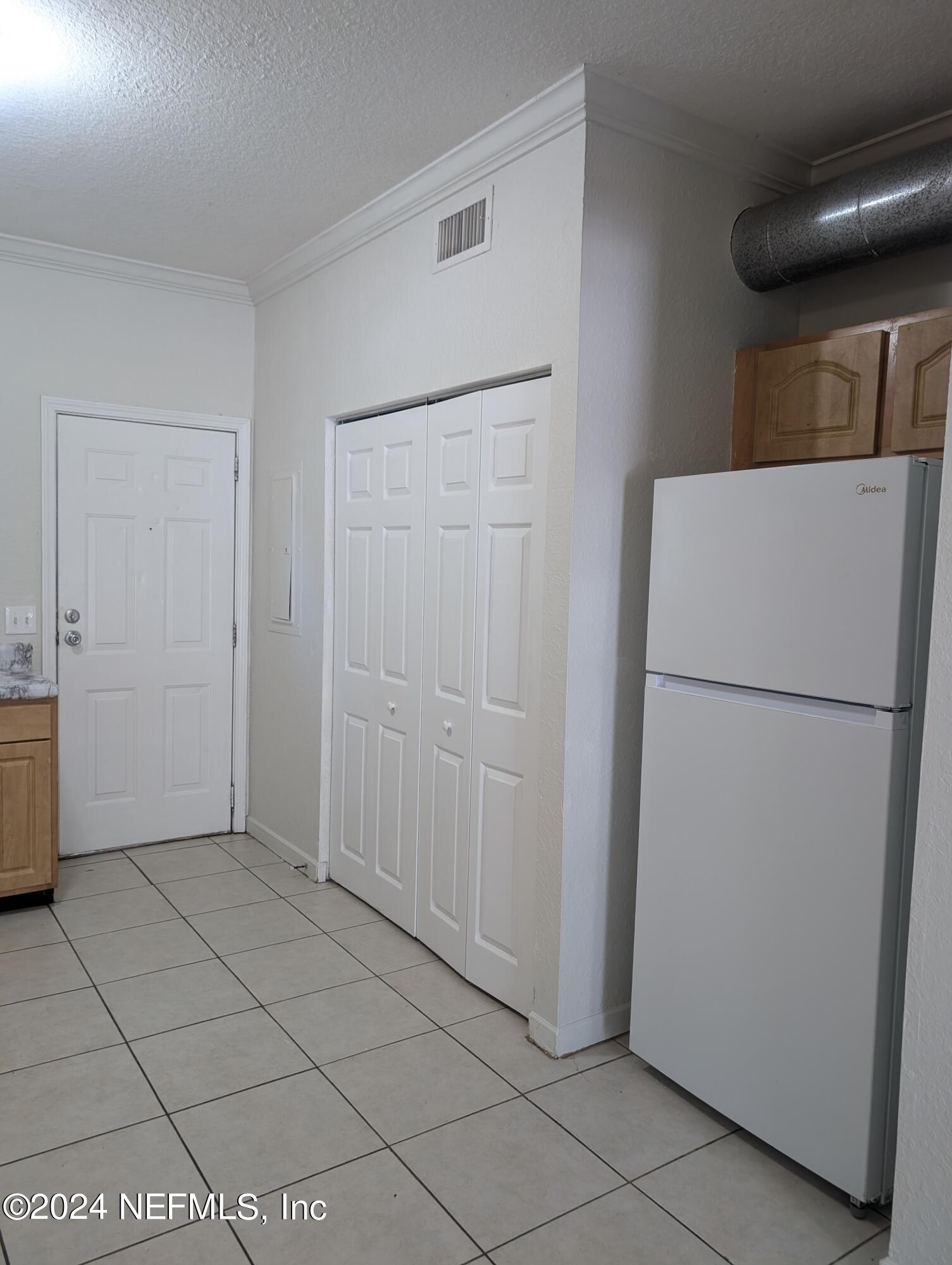 114 Cedar Street, Unit 8 St. Augustine, FL 32084 - Photo 6 of 39 a view of a kitchen with a refrigerator