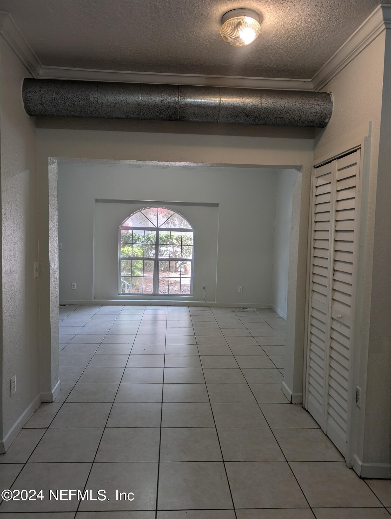 114 Cedar Street, Unit 8 St. Augustine, FL 32084 - Photo 7 of 39 a view of an empty room and window