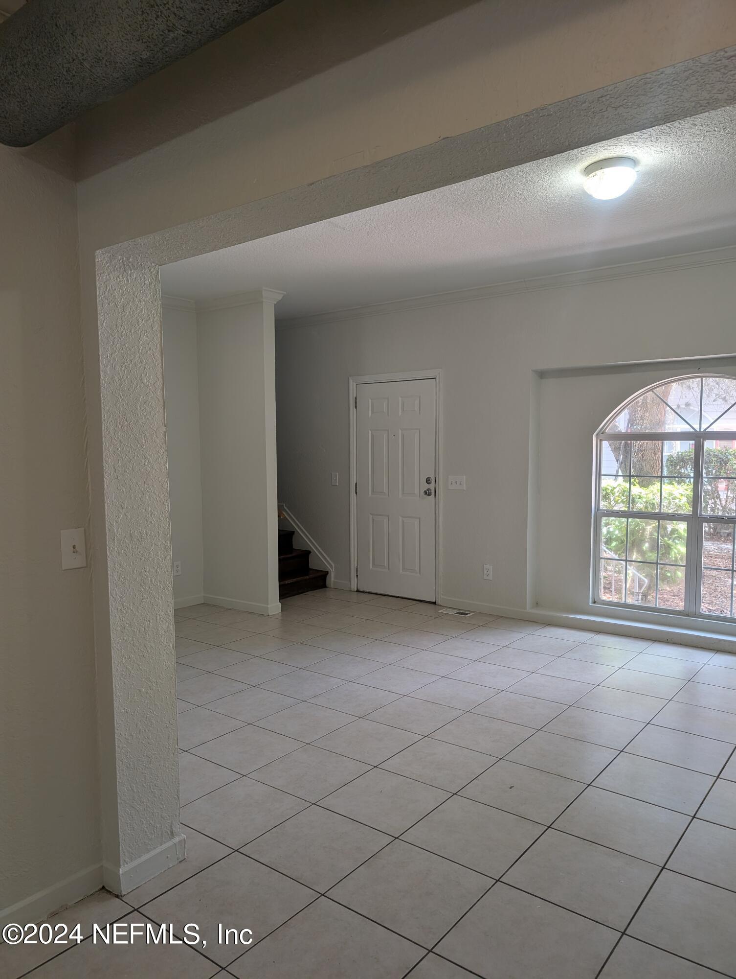 114 Cedar Street, Unit 8 St. Augustine, FL 32084 - Photo 8 of 39 a view of an empty room with a window