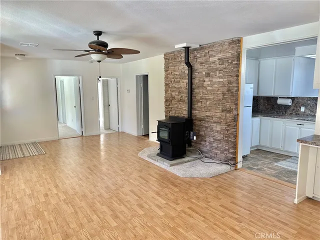 a view of an empty room with a fireplace