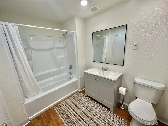 a bathroom with a sink mirror vanity and toilet