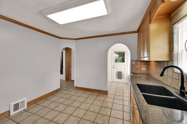 291 800 East Bountiful, UT 84010 - Photo 5 of 20 Kitchen area featuring light-toned tile flooring, light wood cabinetry, and dark countertop with a double basin sink