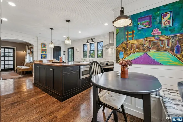 a living room with granite countertop kitchen island furniture and a chandelier