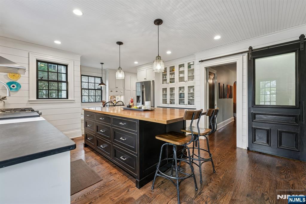 54 Joyce Road Tenafly, NJ 07670 - Photo 13 of 35 a kitchen with wooden cabinets and center island