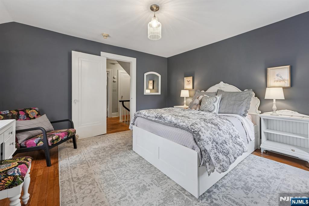 54 Joyce Road Tenafly, NJ 07670 - Photo 19 of 35 a bedroom with a bed and a chandelier