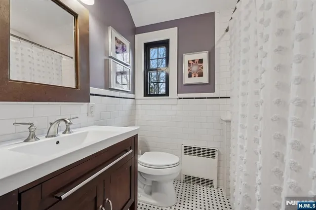 a bathroom with a sink a toilet and a mirror