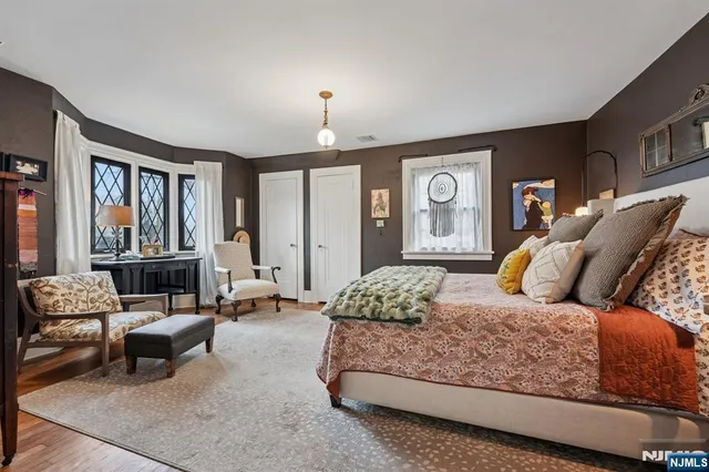 a bedroom with a bed couch and a window