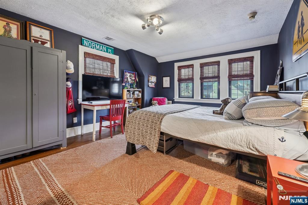 54 Joyce Road Tenafly, NJ 07670 - Photo 25 of 35 a living room with furniture a flat screen tv and a refrigerator