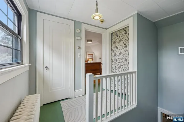 a view of a hallway with windows and stairs