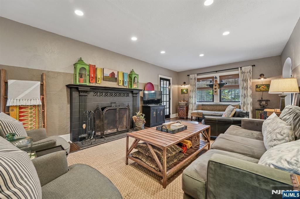 54 Joyce Road Tenafly, NJ 07670 - Photo 7 of 35 a living room with furniture a flat screen tv and a fireplace