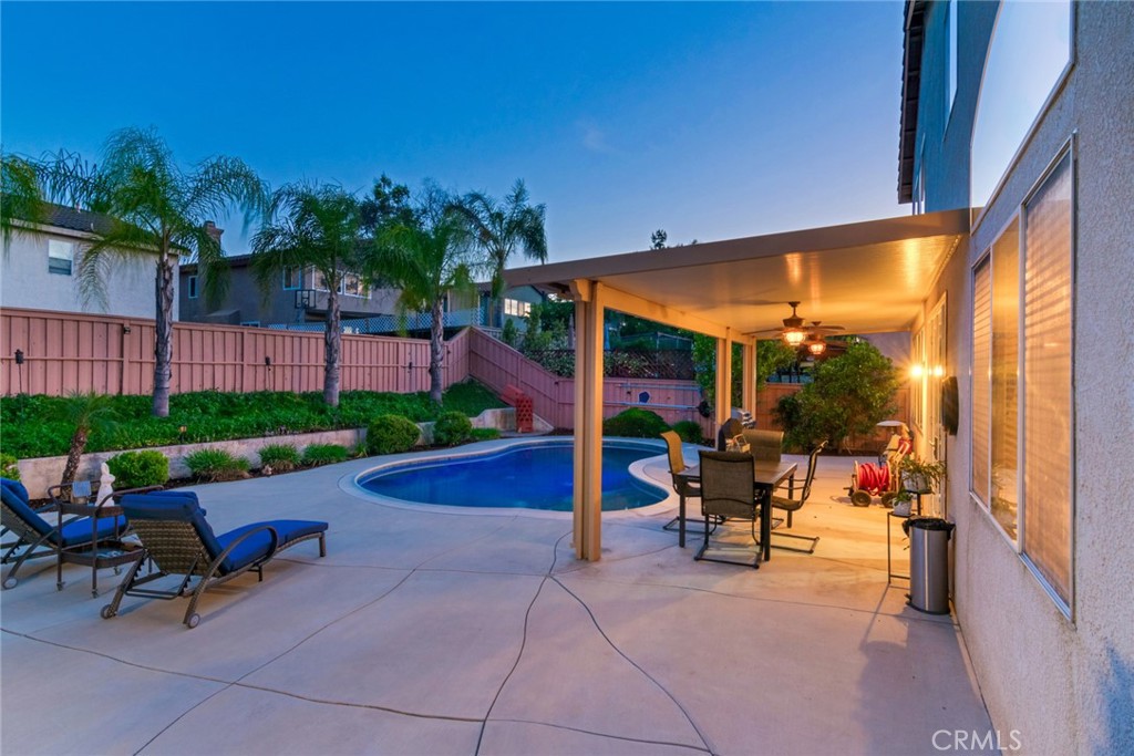 20885 Bakal Drive Riverside, CA 92508 - Photo 38 of 47 a view of a patio with a table and chairs under an umbrella