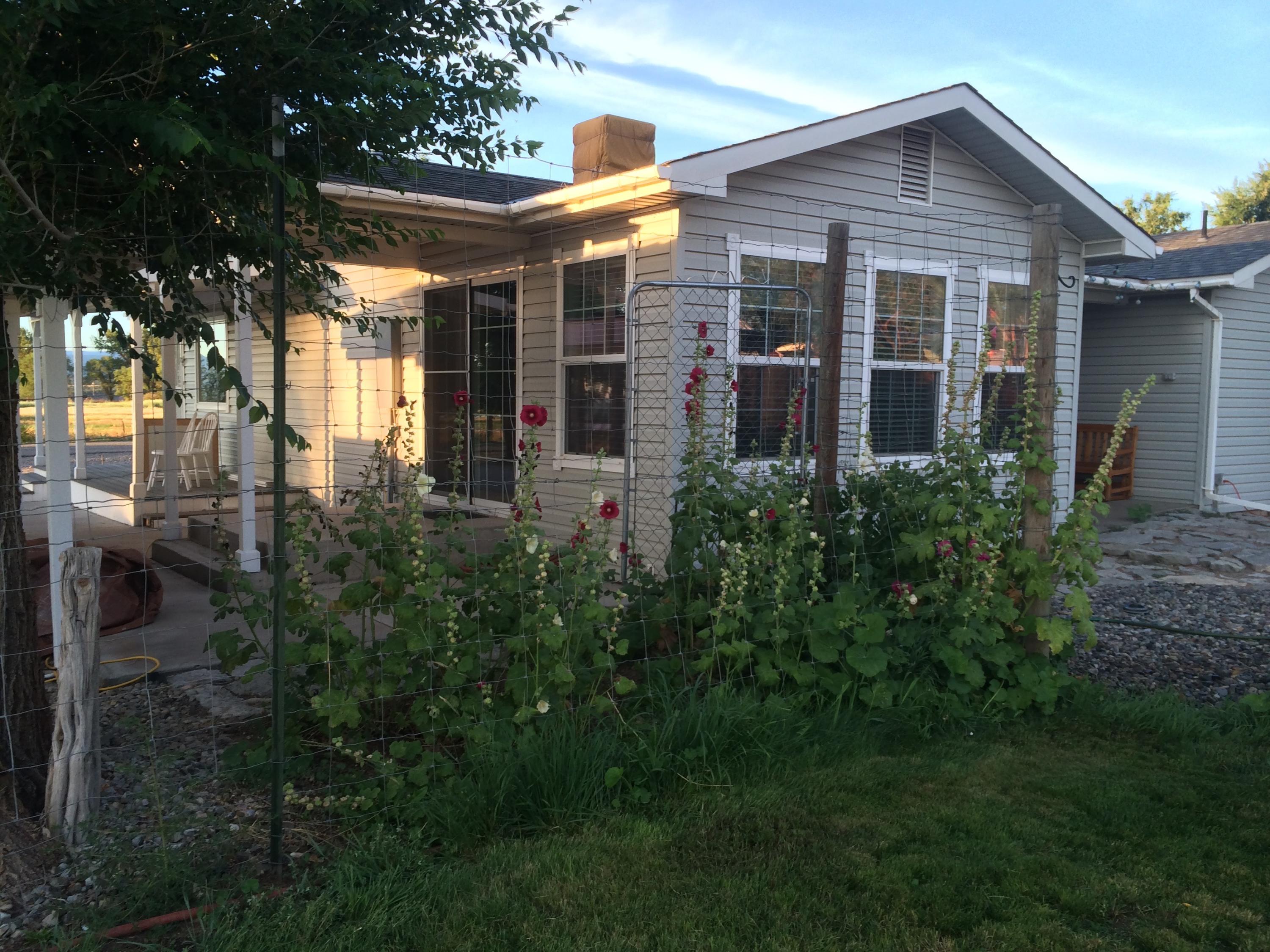 35414 II10 Road Redvale, CO 81431 - Photo 17 of 19 a front view of house with yard and trees around
