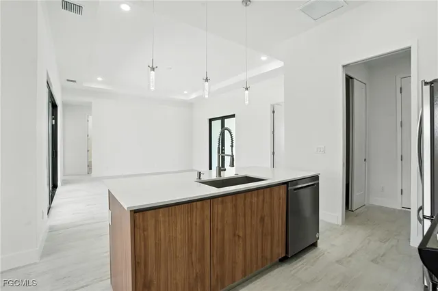 a kitchen with stainless steel appliances granite countertop a sink and refrigerator