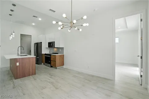 a kitchen with kitchen island a sink stainless steel appliances and cabinets