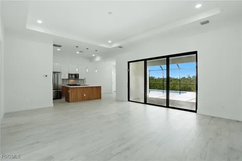 a view of a big room with wooden floor and windows