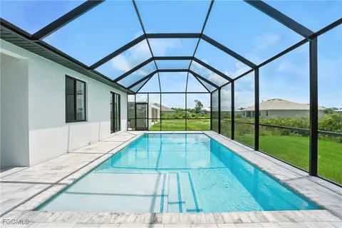 a view of a big house with a big yard and large trees