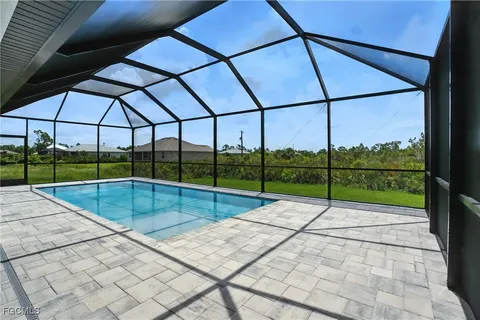 a view of a house with backyard and a garden