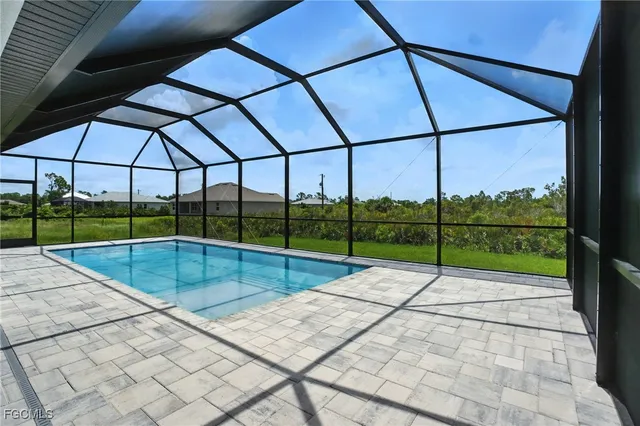 a view of a house with backyard and a garden