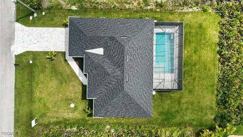 a view of a house with a yard and sitting area