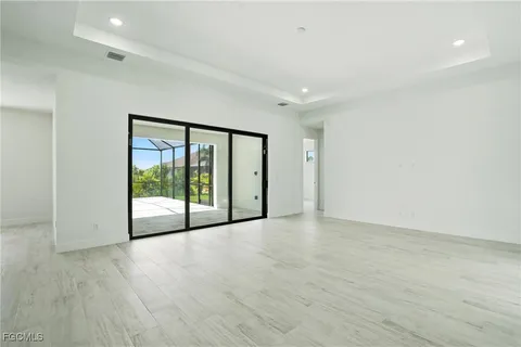 a view of an empty room with glass door