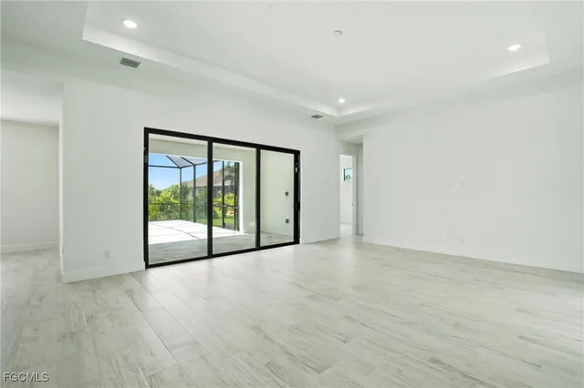 a view of an empty room with glass door