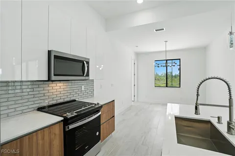 a kitchen with granite countertop a stove and a sink