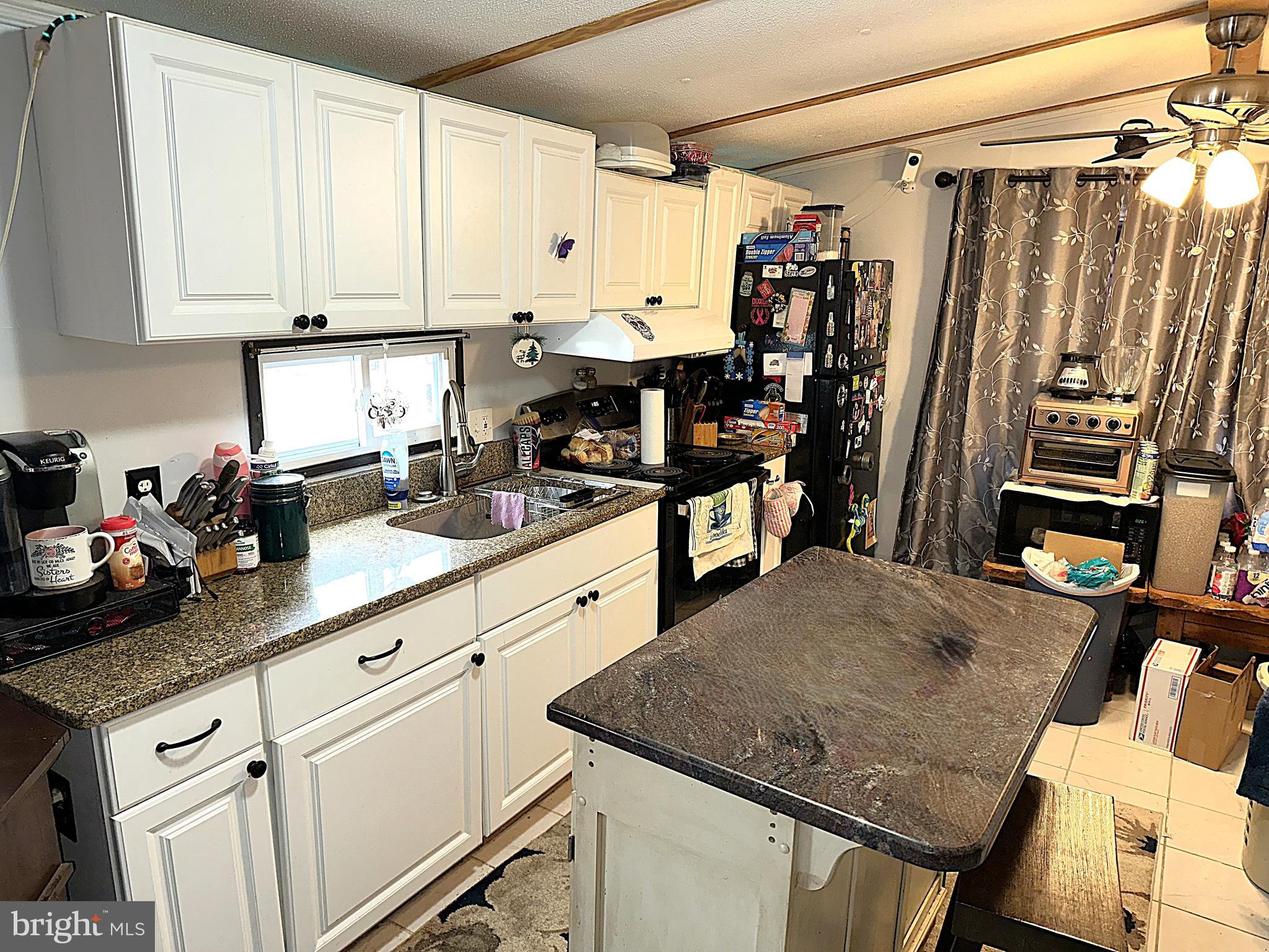 206 5th Street Lothian, MD 20711 - Photo 3 of 16 a kitchen with stainless steel appliances granite countertop a sink refrigerator and cabinets